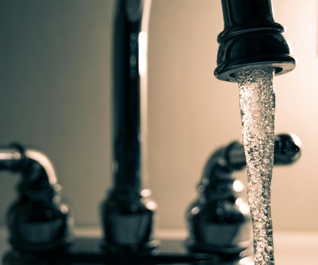Chrome kitchen sink with water coming our of the tap. Smiths Falls encourages lead testing for residents’ water safety