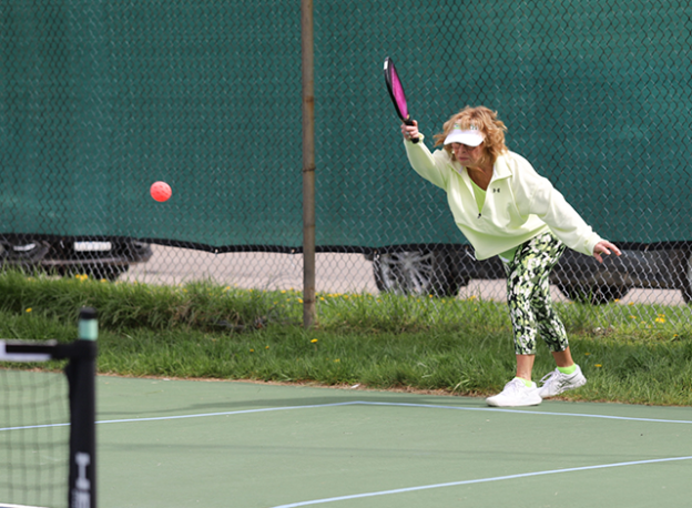 Patricia Lynch serves during a pickleball open house.