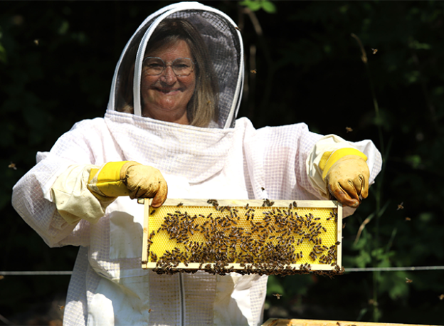 Annelle Lalonde holding beehive