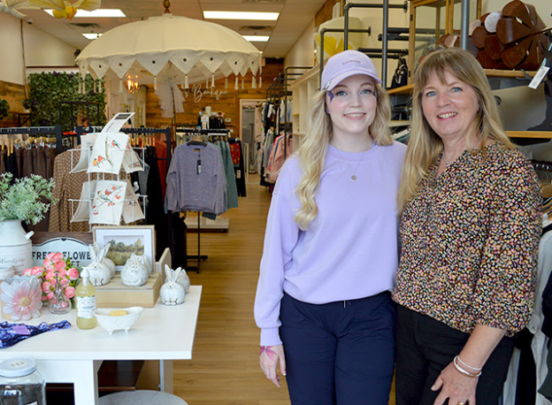 Jackie Taylor and her daughter, Lyndsay, pose inside boutique shop.