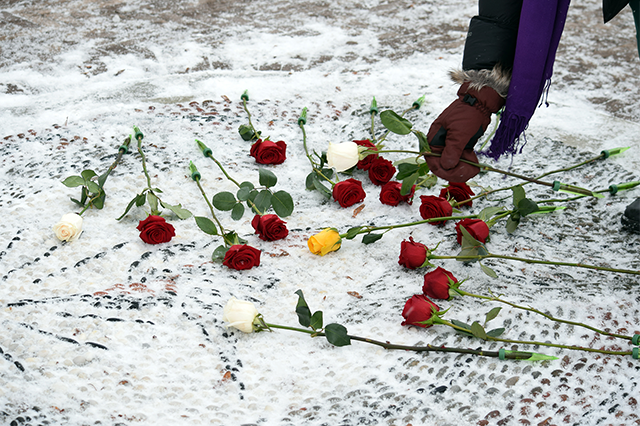 Roses are laid on the Smiths Falls memorial mosaic.