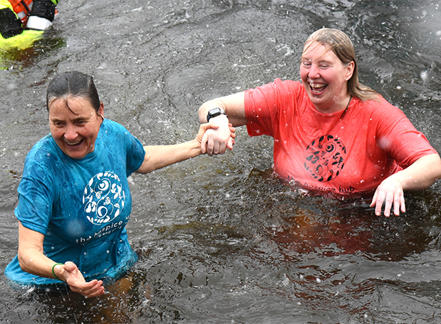 Perth Polar Bear Plunge contestants in the ice water with big smiles for a good cause.