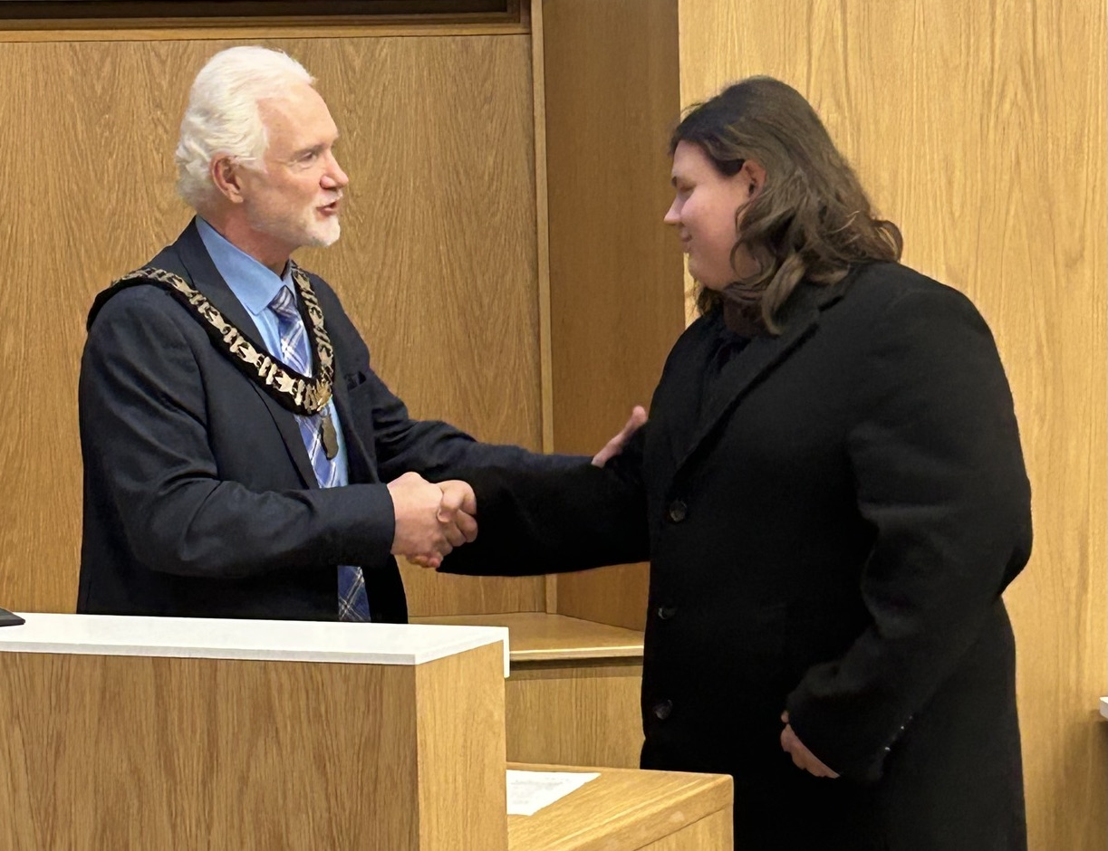 Mayor Shawn Pankow shaking the hand of student councillor Ryan Hooper.