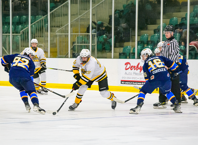 Smiths Falls Bears Junior A hockey team taking the puck up ice. Renfrew Wolves chase.